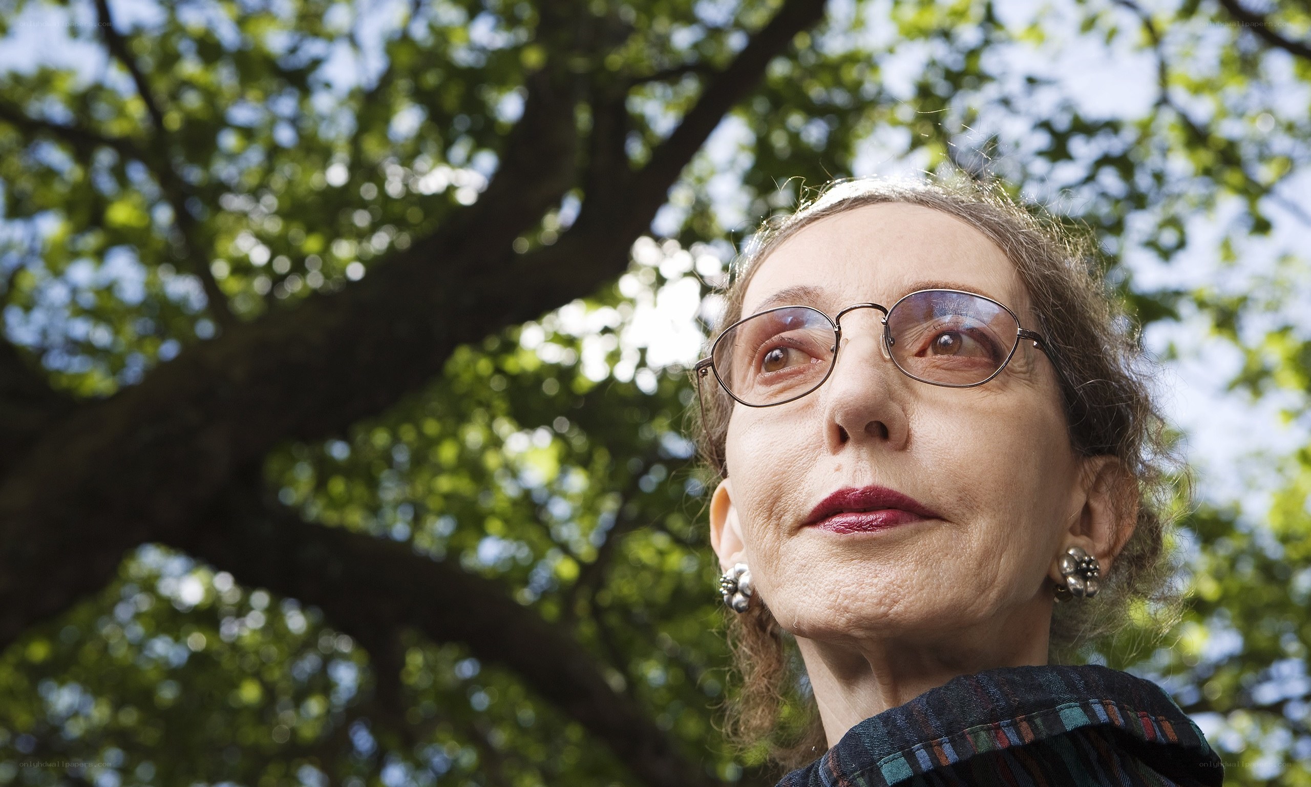 woman in glasses under tree