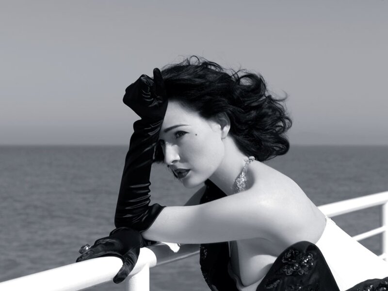 woman in gloves by the sea