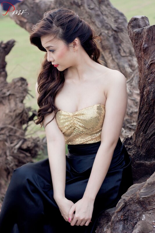 Woman in gold and black dress