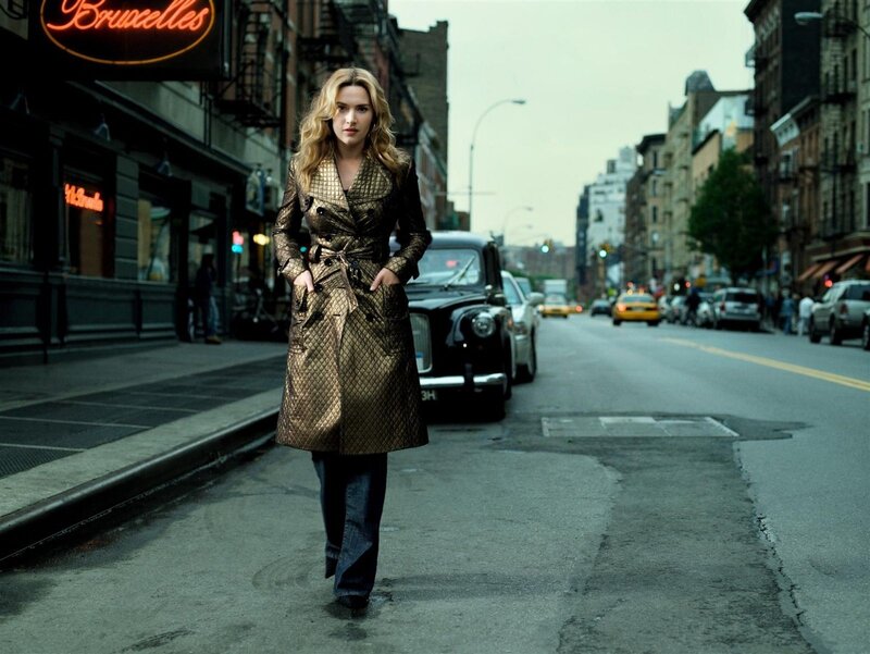 Woman in gold coat on city street