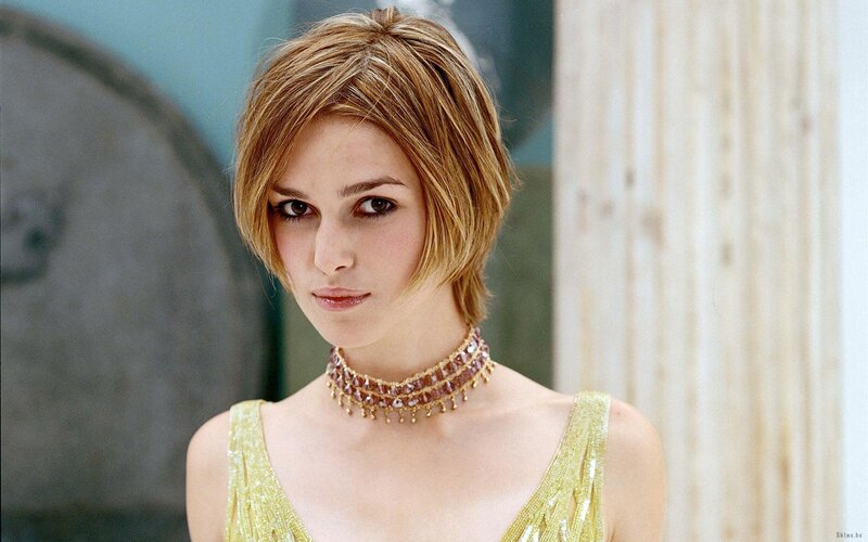 woman in gold dress and necklace