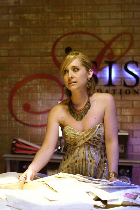 Woman in gold dress at desk