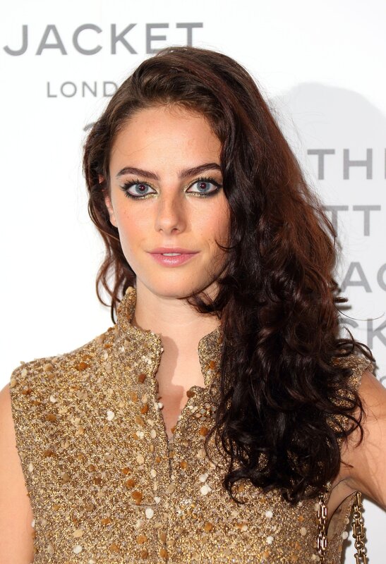 woman in gold dress at event