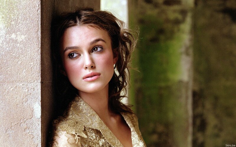 woman in gold dress leaning