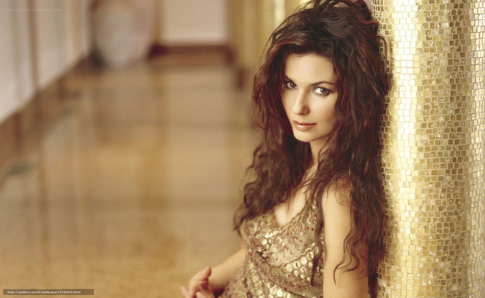 woman in gold dress leaning