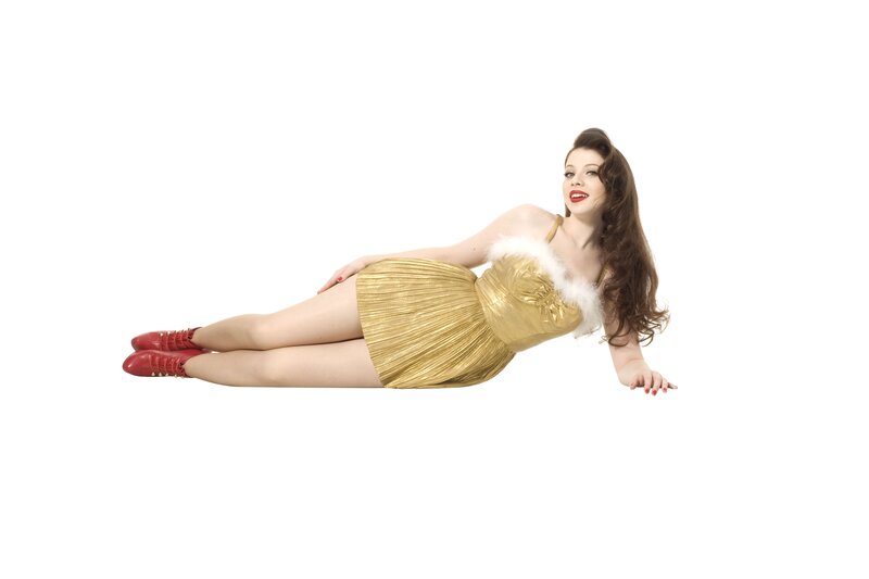 woman in gold dress lying down