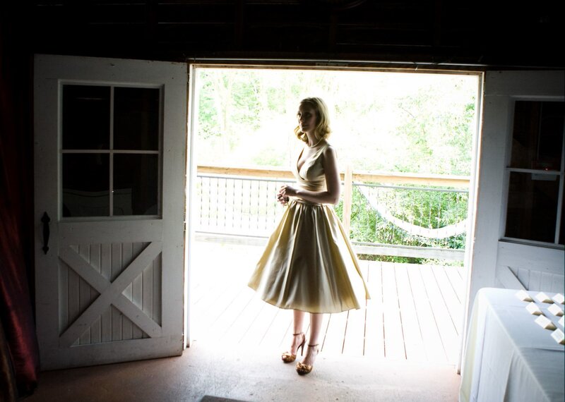 Woman in gold dress on porch