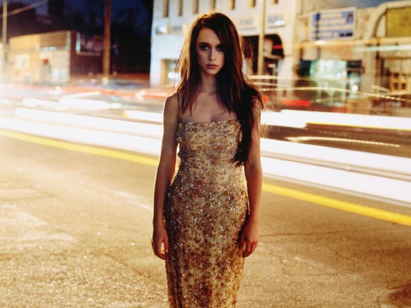 woman in gold dress on street