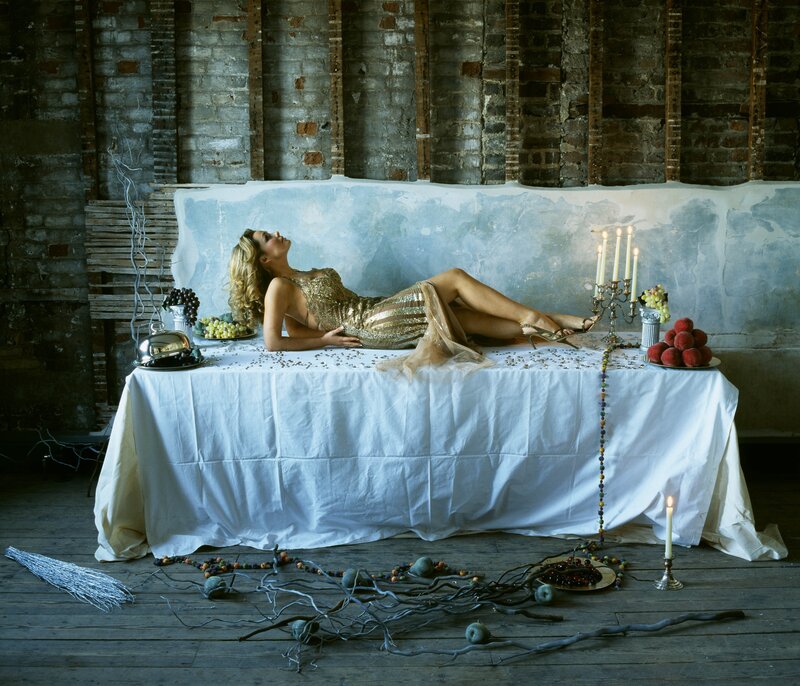Woman in gold dress on table