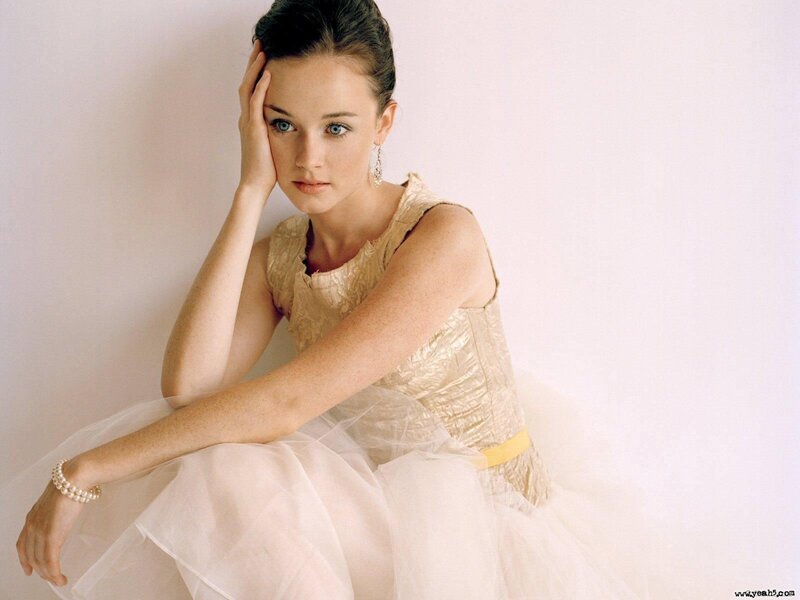 woman in gold dress posing