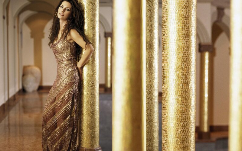 woman in gold dress posing