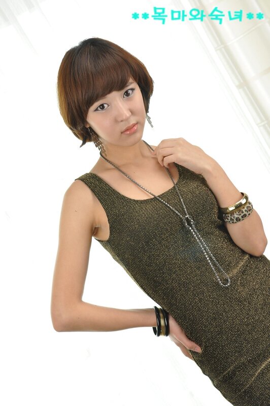 woman in gold dress posing