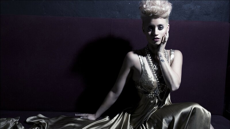 woman in gold dress posing