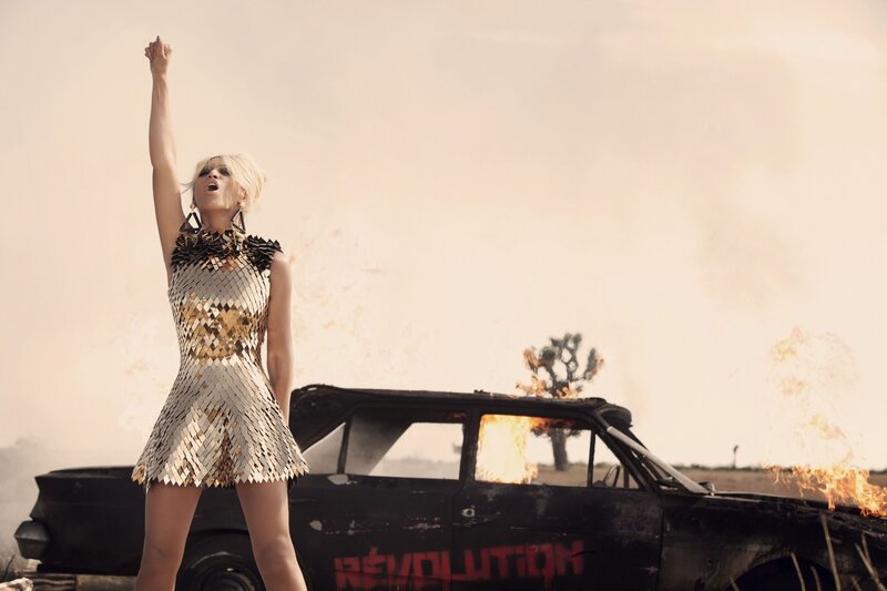 woman in gold dress with burning car