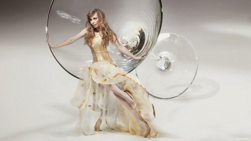 woman in gold dress with wine glass