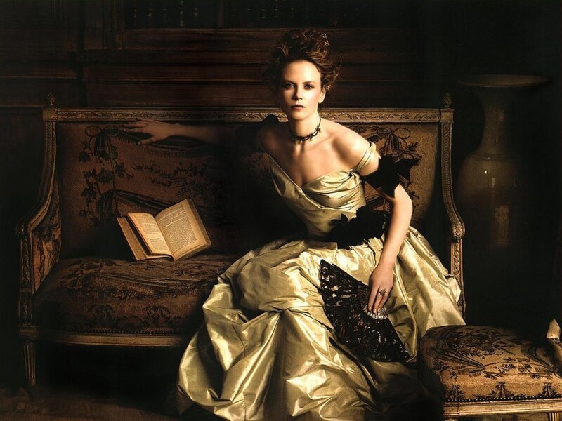 Woman in gold gown on sofa