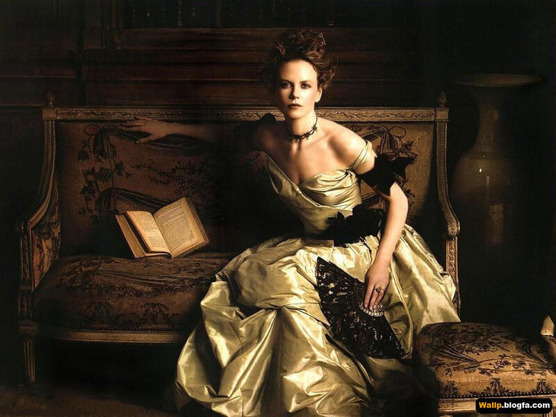 Woman in gold gown on sofa