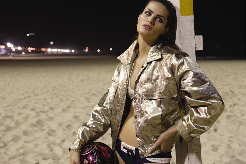 woman in gold jacket on beach