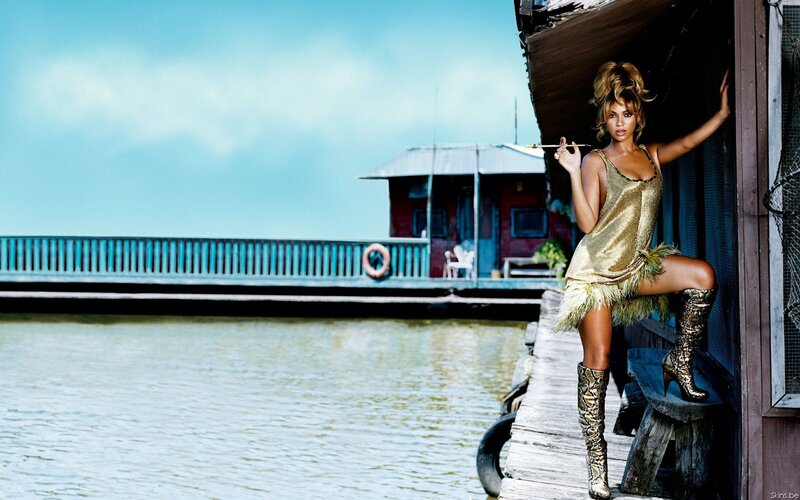 woman in gold outfit on dock