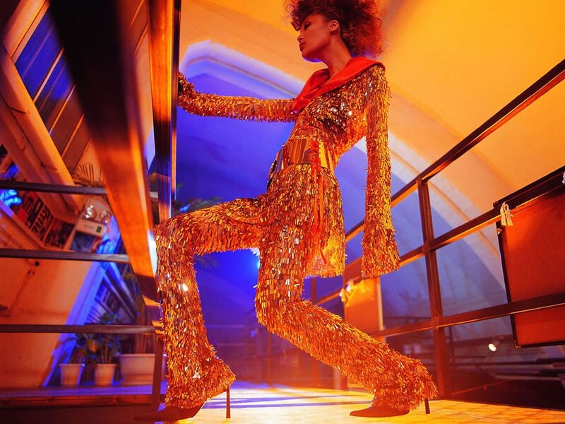 woman in gold sequin outfit