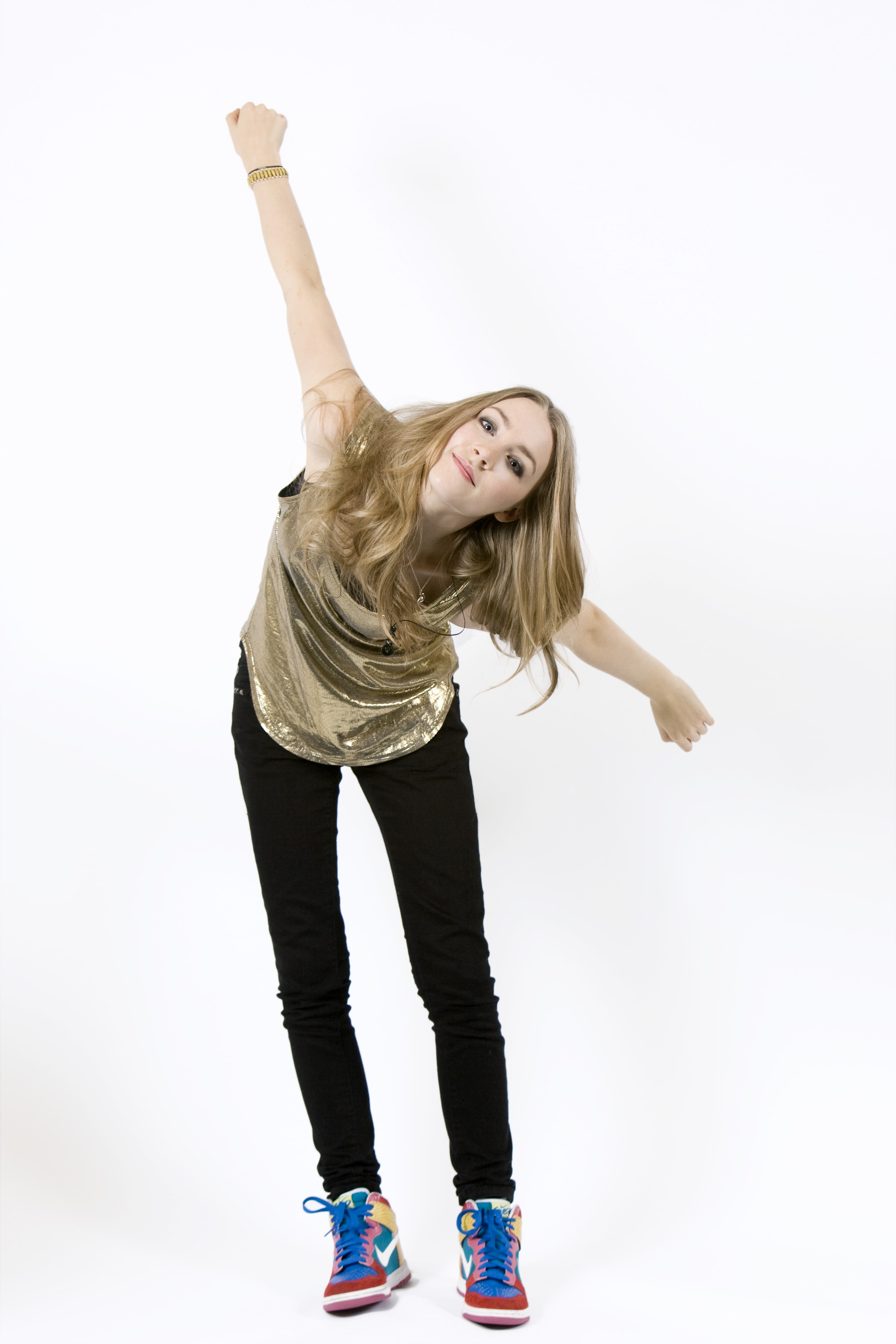 woman in gold top dancing