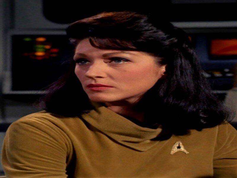 Woman in Gold Uniform — Serious