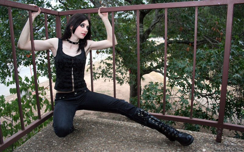 woman in goth attire on balcony