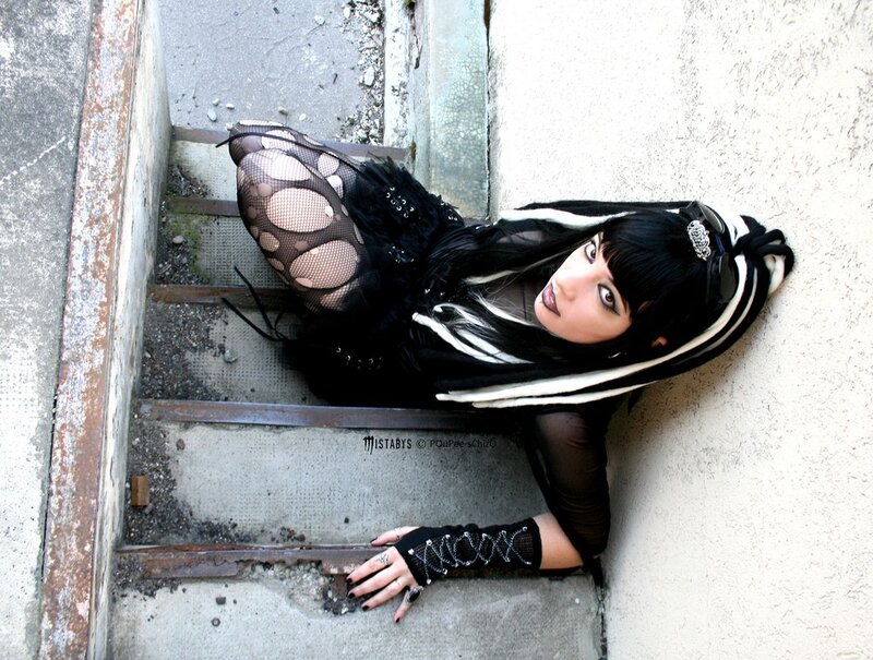 woman in goth attire on stairs