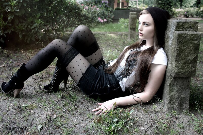 woman in goth style sitting outdoors