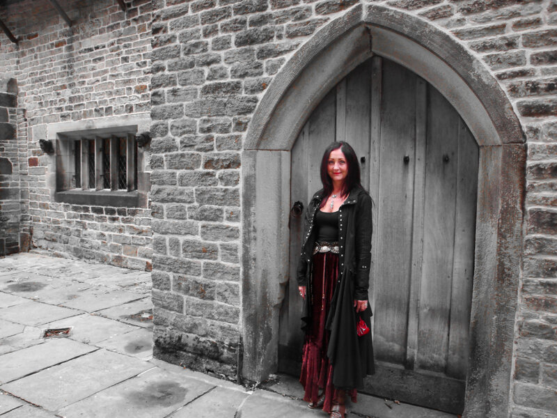 woman in gothic attire at stone door