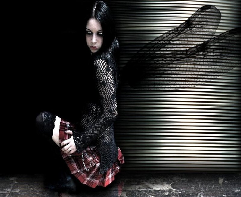 woman in gothic attire crouching