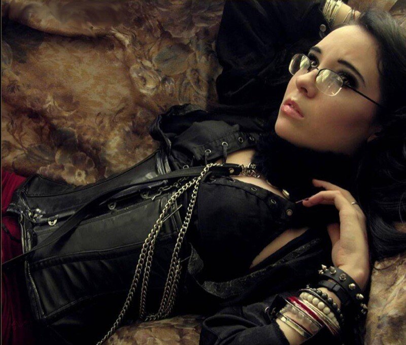 woman in gothic attire lying down