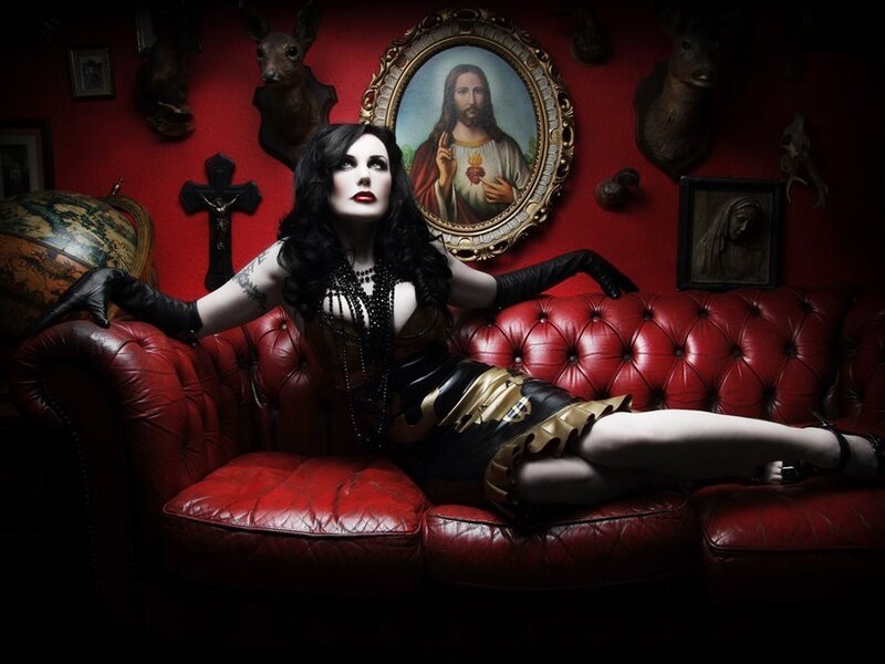 woman in gothic attire on red couch