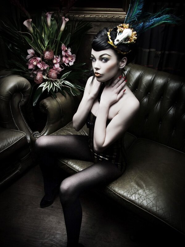 woman in gothic attire on sofa