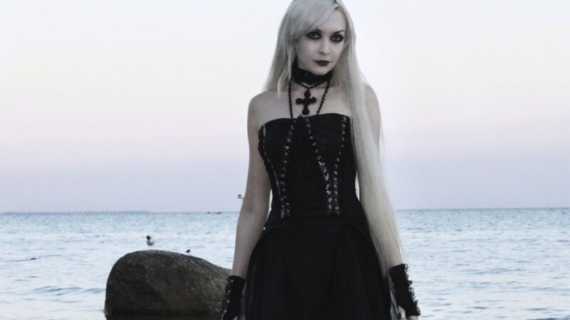 woman in gothic dress at beach