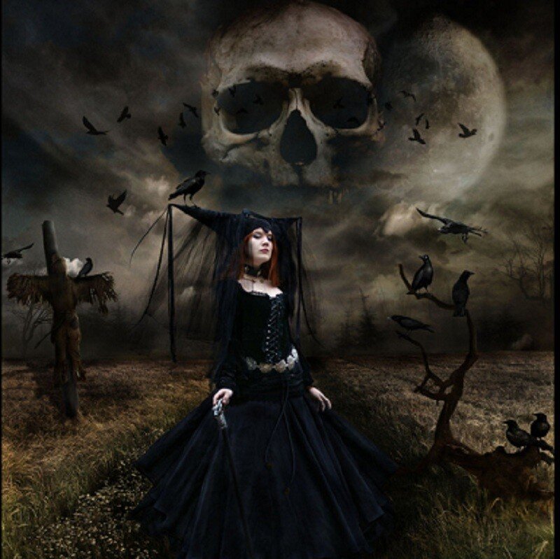 woman in gothic dress with skull
