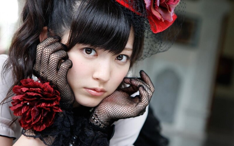woman in gothic style with red flowers