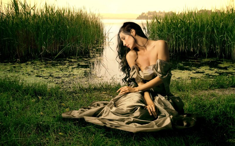 Woman in gown by lake