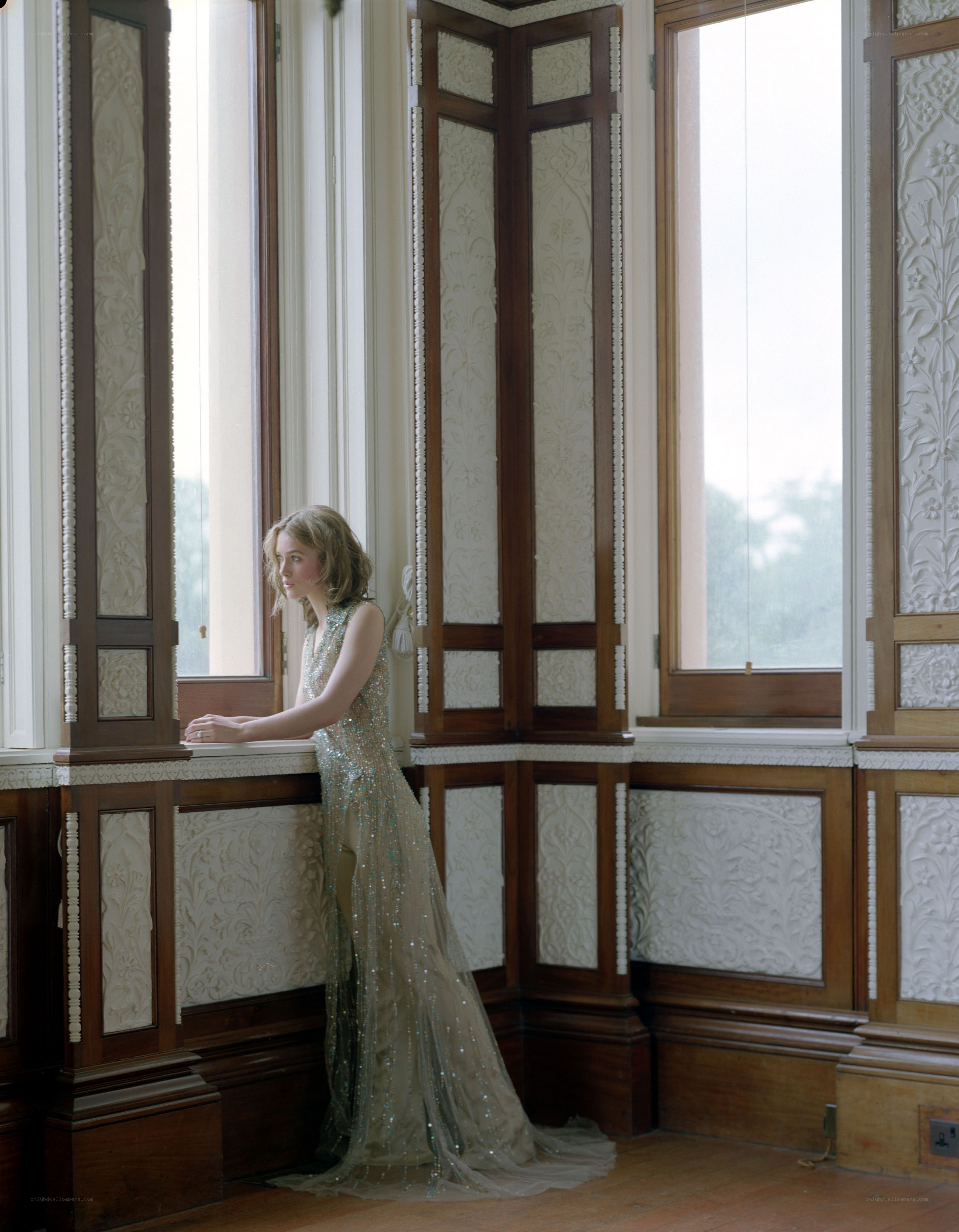 Woman in gown by window