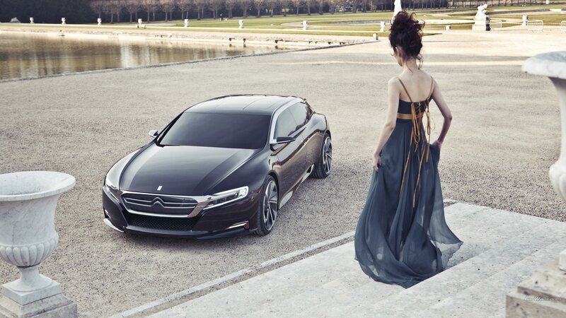 Woman in gown near luxury car