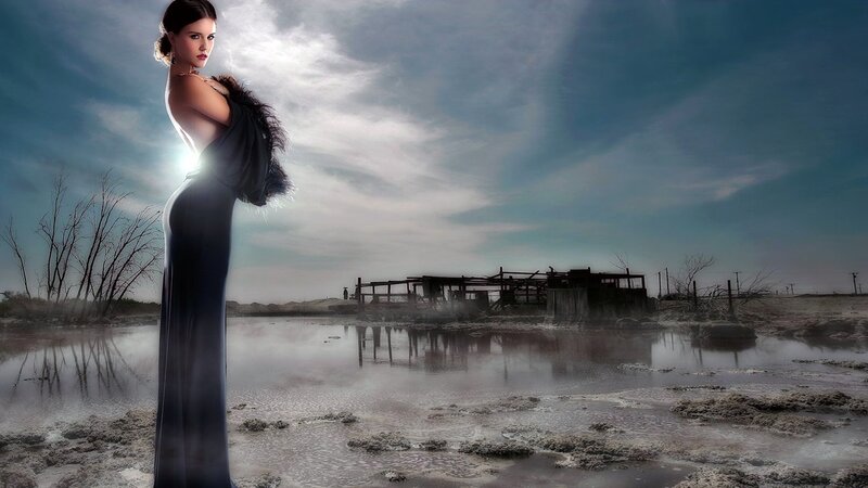 woman in gown on desolate shore