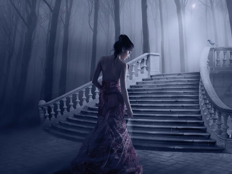 Woman in gown on misty stairs