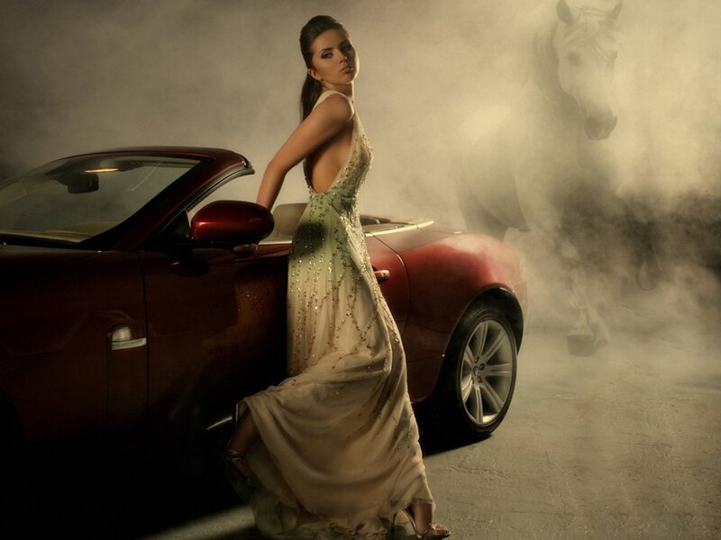 woman in gown with red car