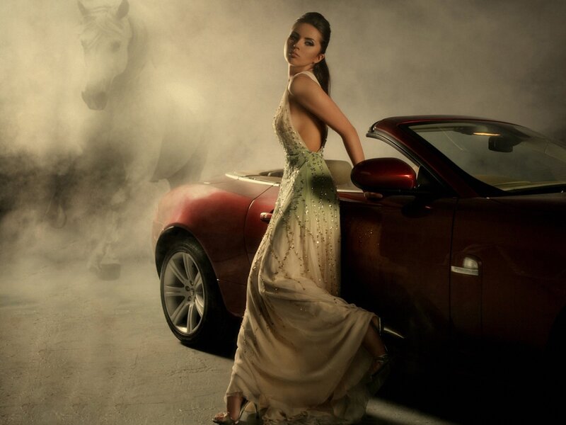 Woman in gown with red car