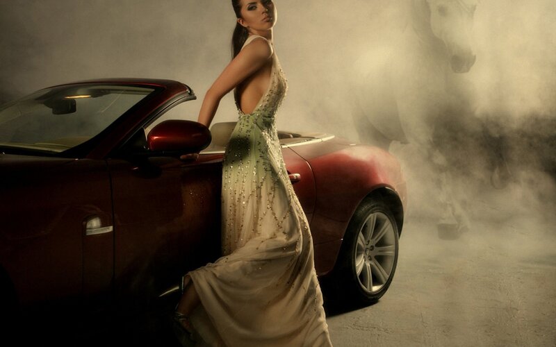 Woman in gown with red car