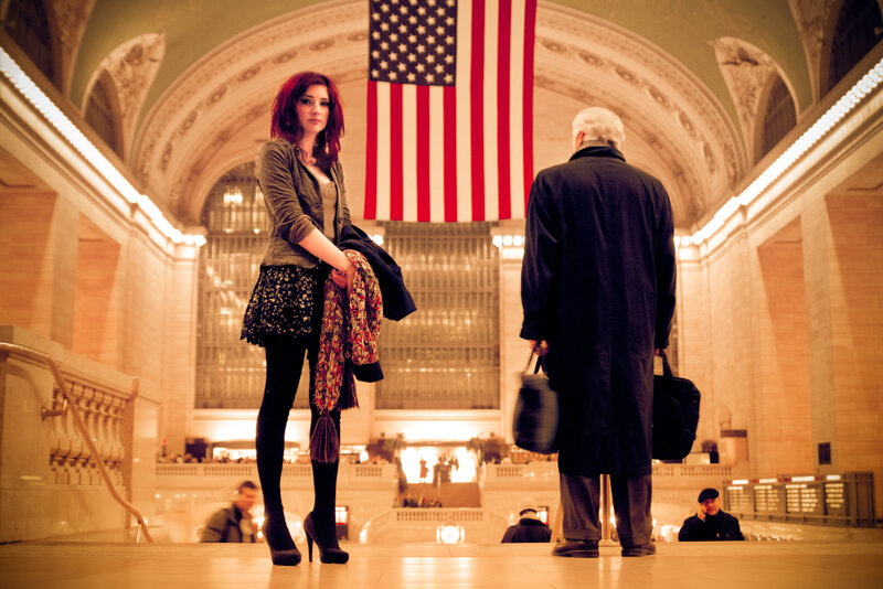 woman in grand hall with flag