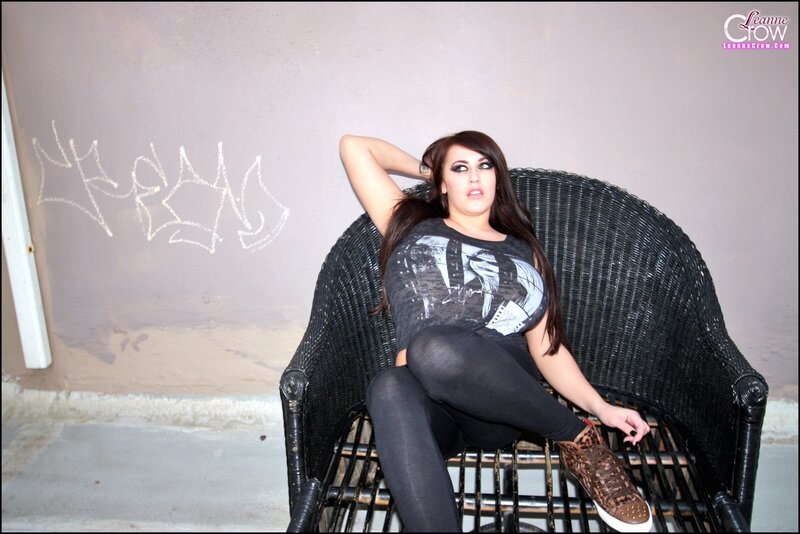 Woman in graphic tee on wicker chair