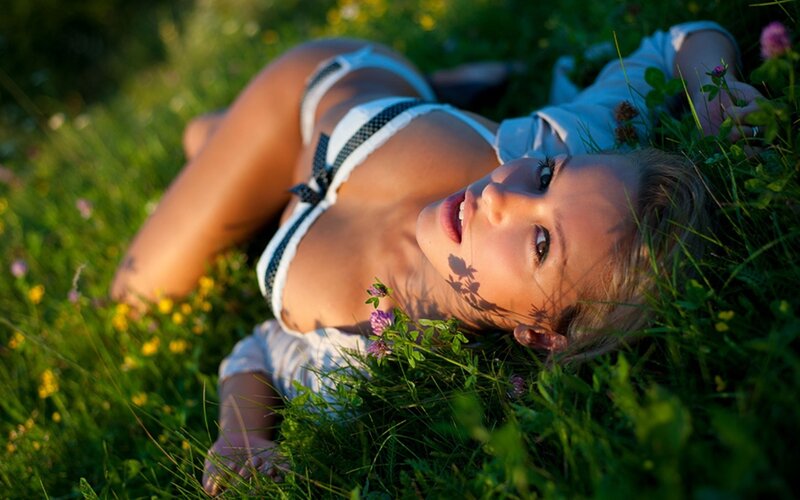 woman in grass with flowers