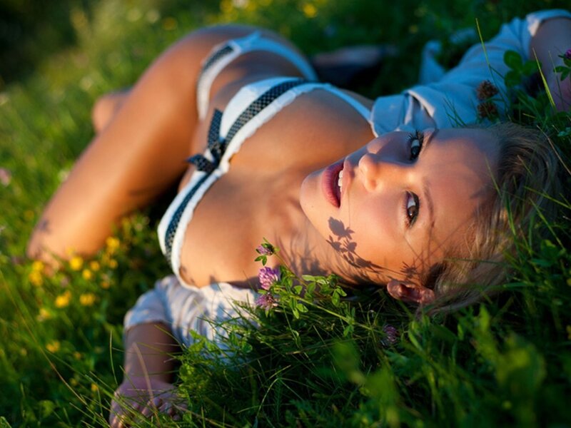 woman in grass with flowers
