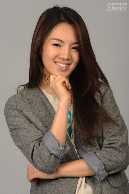 woman in gray blazer smiling